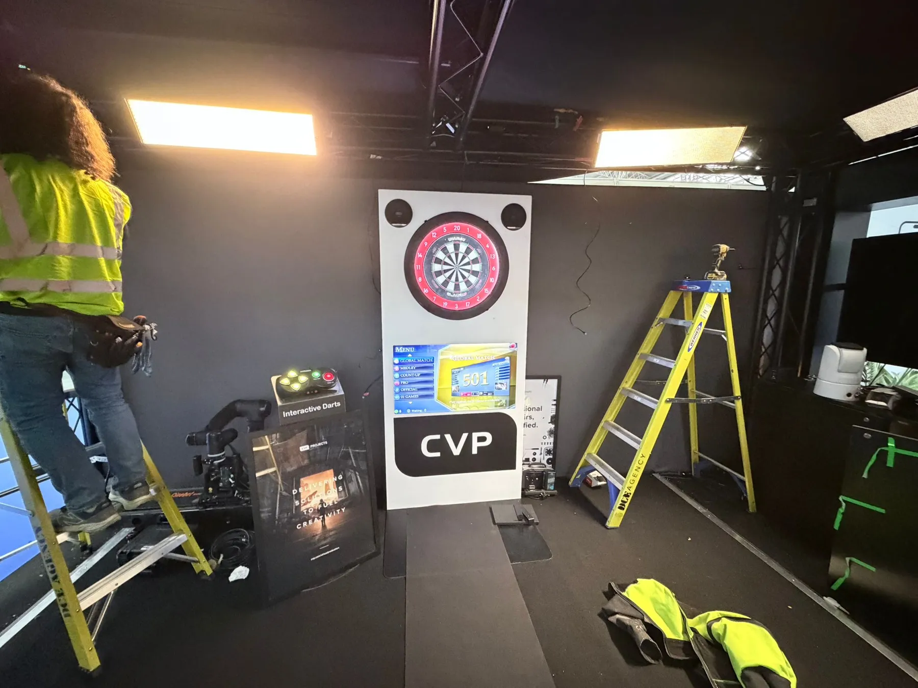 Branded interactive dartboard being installed on the CVP exhibition stand