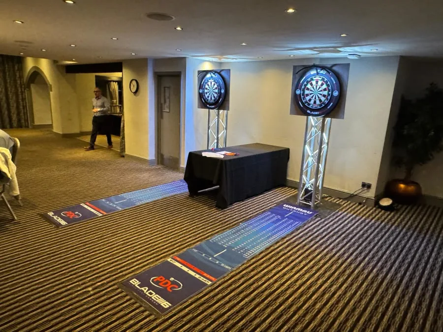 Traditional dartboards on truss stands at a hotel event