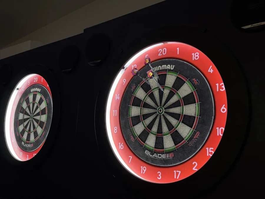 Close-up of an LED auto scoring dartboard with darts in the treble 20